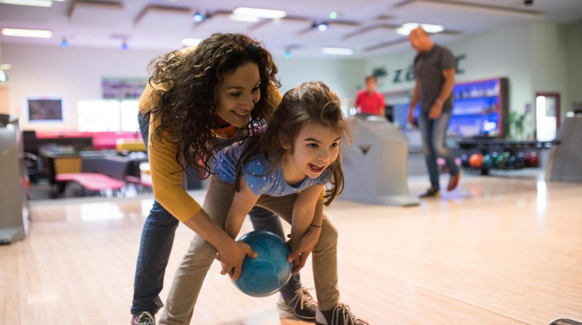 Mother and daughter bowling in a Seattle area bowling alley