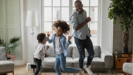 Family being active indoors dancing 