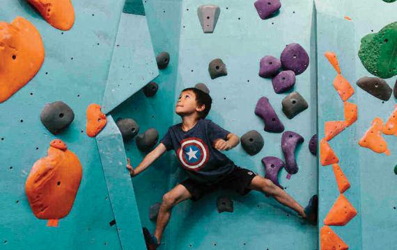 little boy rock climbing