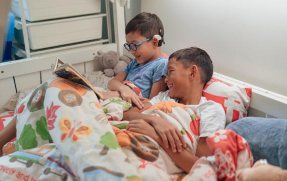 Brothers reading a book with deaf characters
