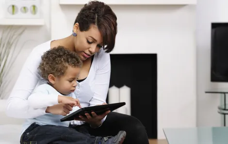 mother and toddler watching TV on iPad