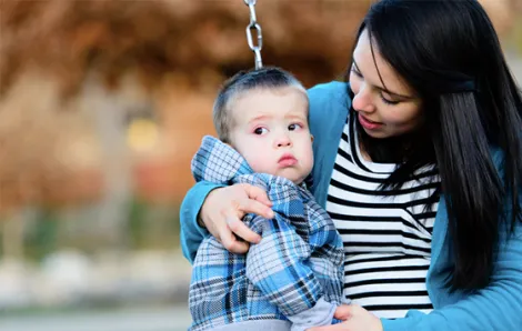 Mom with son on swings