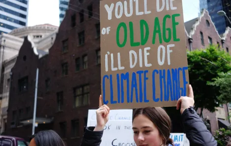 Young woman holding a sign at a climate action strike