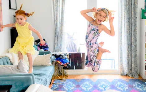 girls jumping and dancing on furnture active at-home recess ideas for remote learning