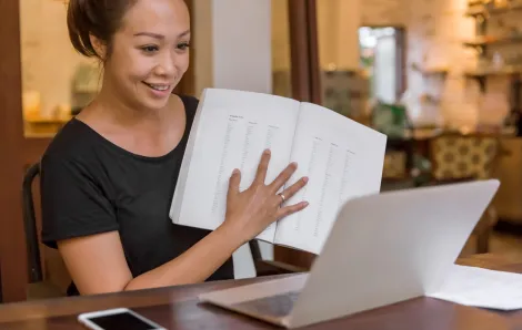woman teaching in front of her laptop smiling