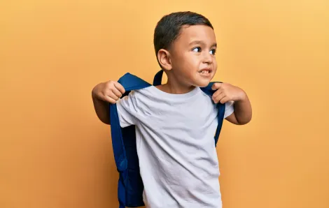 cute latino toddler wearing a backpack