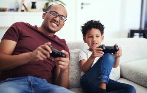 Dad-and-young-son-playing-video-games