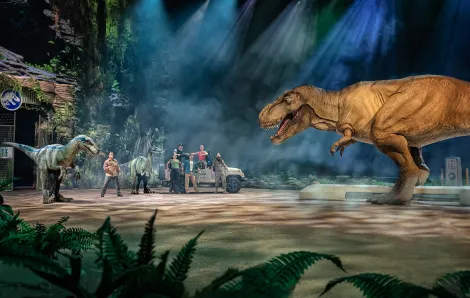 Scene from the dinosaur show called Jurassic World Live Tour with T. rex facing human