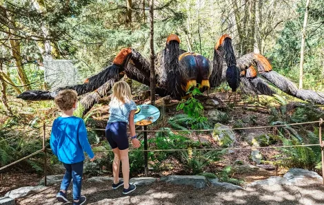 Two kids inspect the giant tarantula on display at Seattle's Woodland Park new temporary exhibit A Bug's Eye View summer 2023