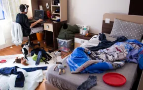 Teenage boy in a messy bedroom