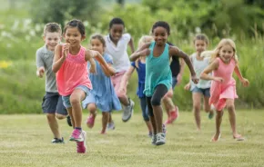 Group of kids running in a field benefits of running