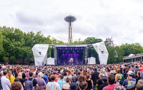 Bumbershoot stage with crowd and Space Needle in the background at Seattle Center