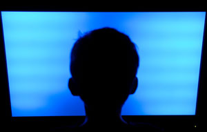 boy looking at blue screen
