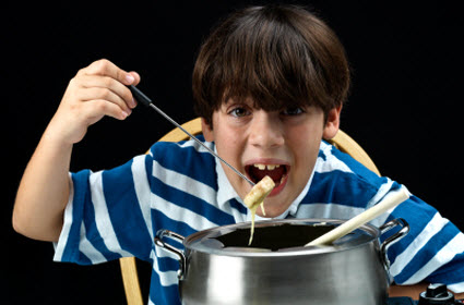 Boy eating fondue