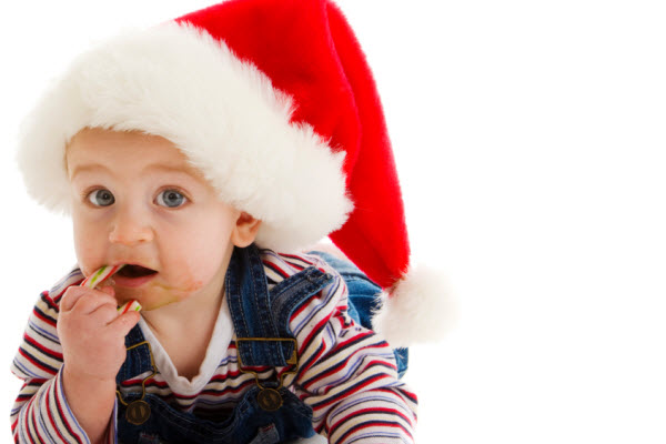 Baby with candy cane and santa hat