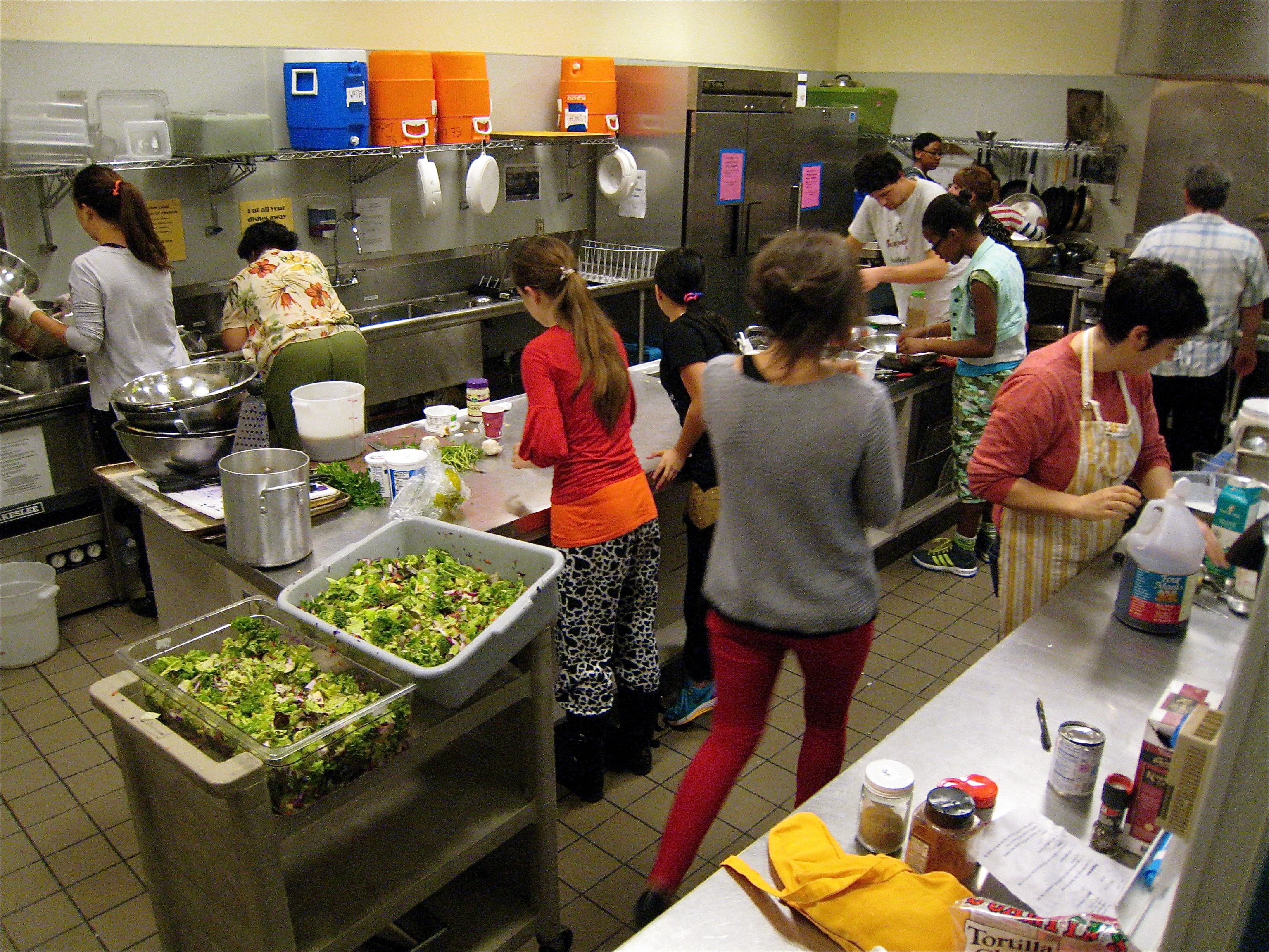 Rainier Community Center kitchen volunteers busily cooking for 60-80 diners