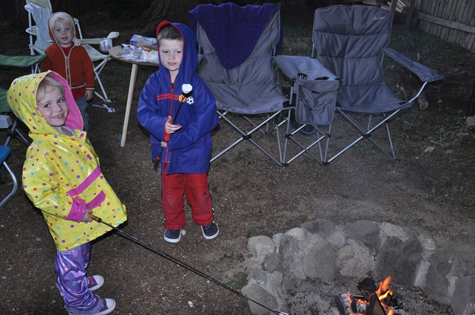 Kids roasting marshmallows in rain