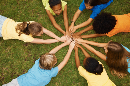 Children in a circle with hands together
