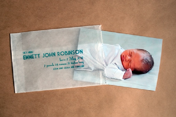 Clear envelopes with baby's picture behind them