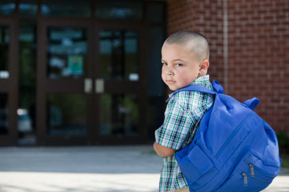 boy looking back as he goes to school