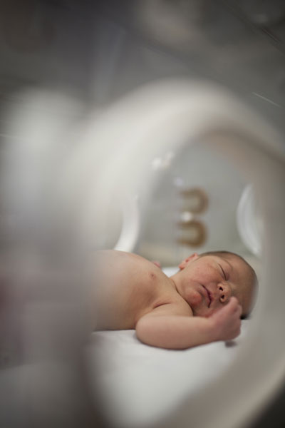 Preemie baby in hospital on incubator