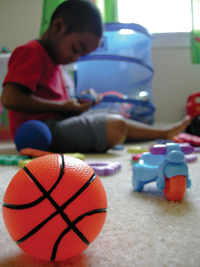 Boy sitting with toys