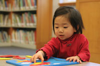 Girl with puzzle at the library