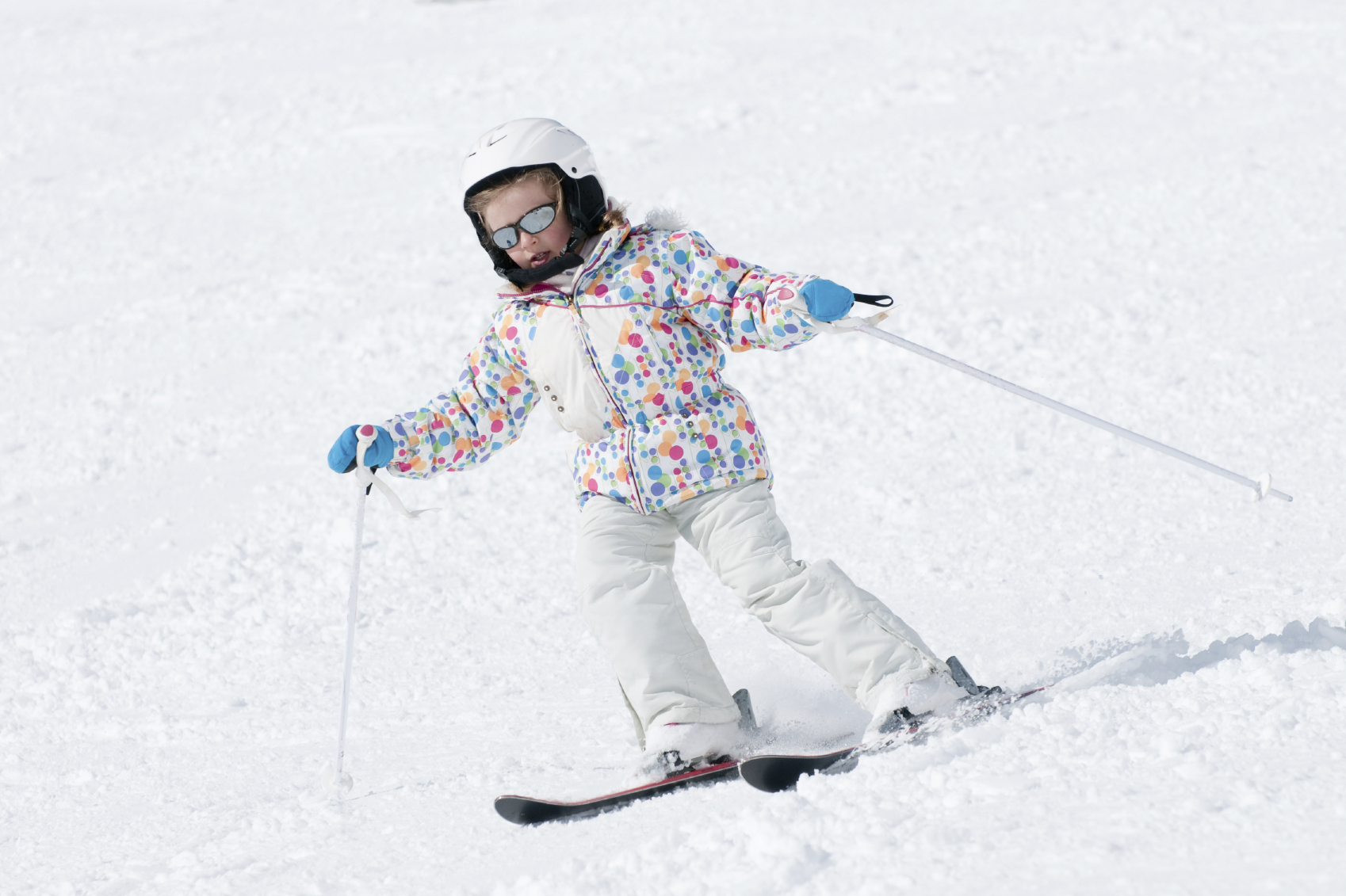 kid on the ski hill with a helmet