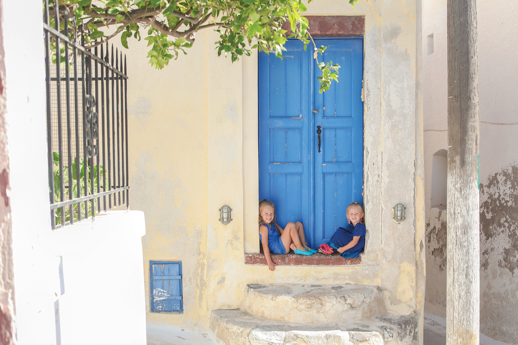 how to take a year off with kids how they did it traveling to greece little girls in doorway