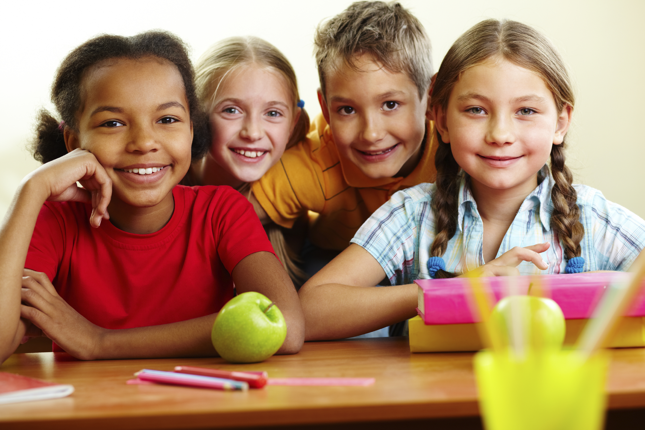 Elementary school happy classmates at desk