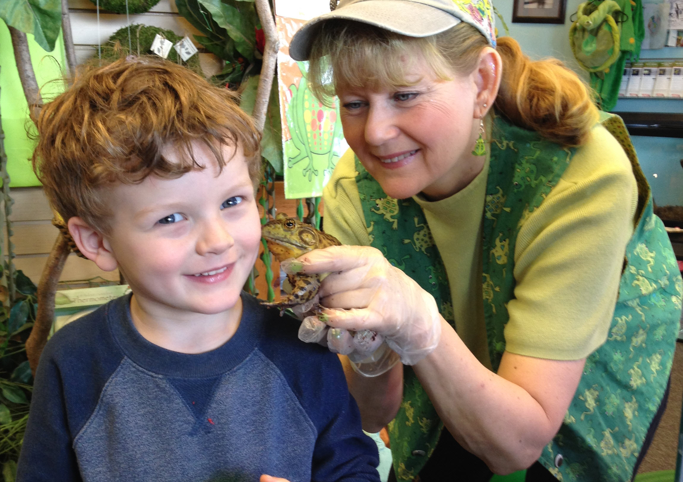 The Frog Lady and one of her bullfrog greets a 5-year-old boy
