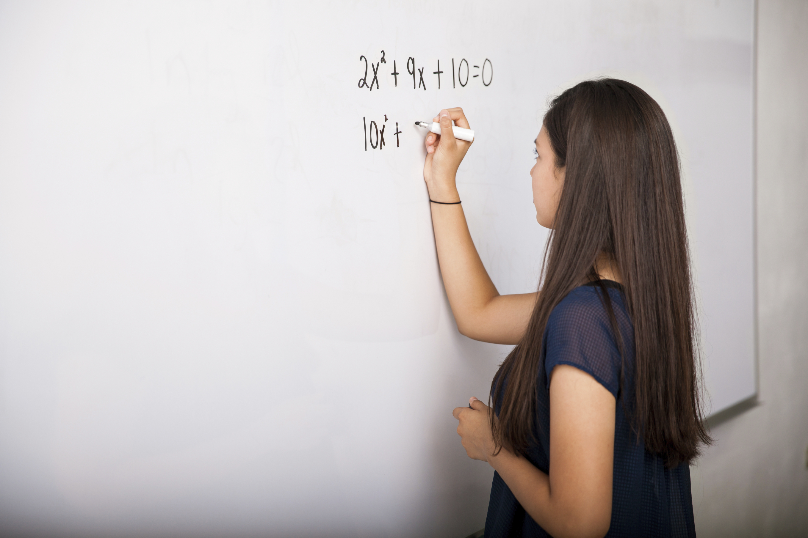 girl doing math on whiteboard