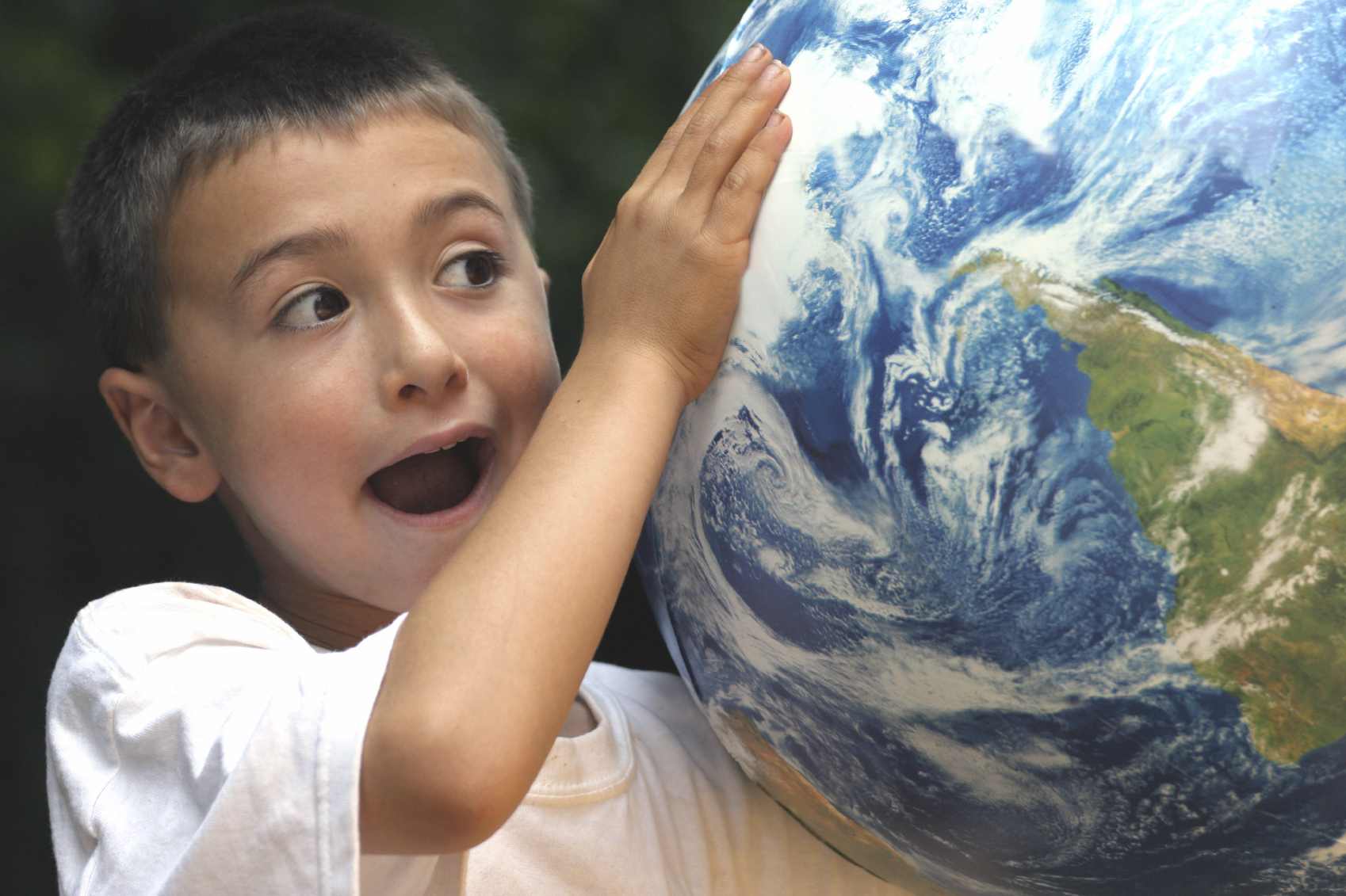 TCK boy holding globe