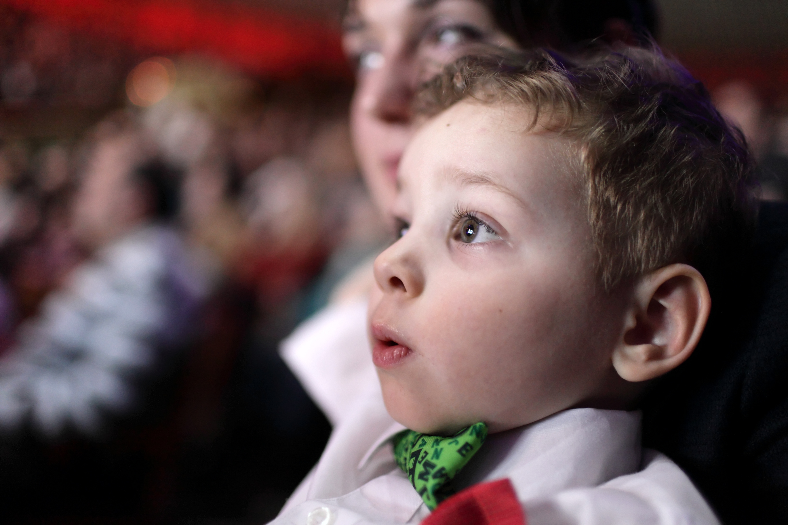 Little boy looking at show with wide eyes while wearing a bow tie