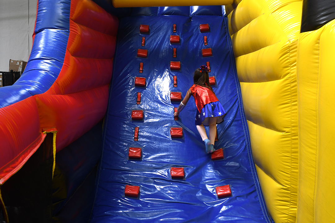 A girl climbs up to the top of the giant inflatable slide at Arena Sports’ new family entertainment center in Issaquah, Wash., near Seattle