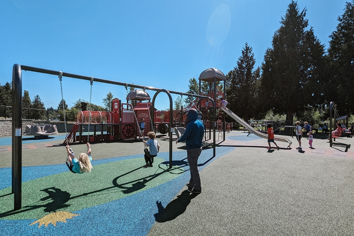Kids swing on the swing set at Ballinger Park's new playground