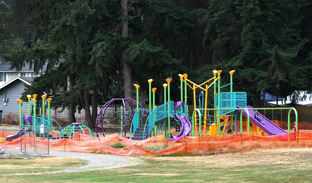 Orange netting surrounds landscaping in progress around the recently opened new playground at Cascade Park in Renton, a city near Seattle