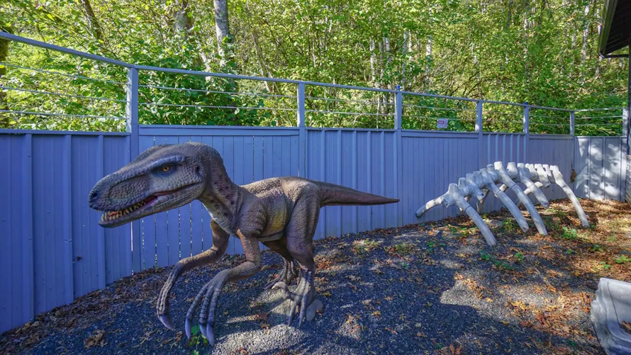 "Life size dinosaur outside side the unique Airbnb Jurassic Retreat"