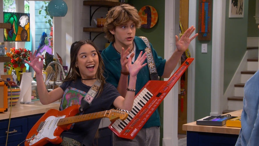 "Teenage boy and girl playing guitar instruments"