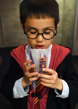 Boy tries butterbeer at the Harry Potter: Magic at Play exhibit in Bellevue near Seattle