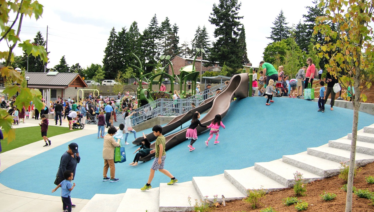 Crowds of kids and adults at Bellevue Downtown Park's new Inspiration Playground during the opening day in 2017