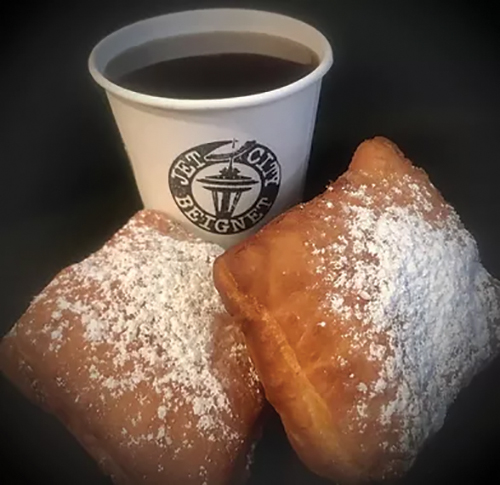 "Cup of coffee and two beignets"