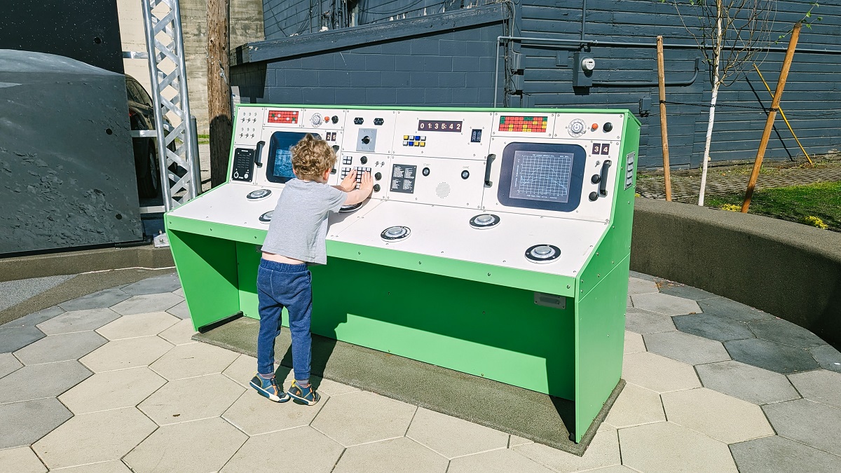 A young boy plays with the mission control play feature at Kent's newly updated and space themed Kherson Park