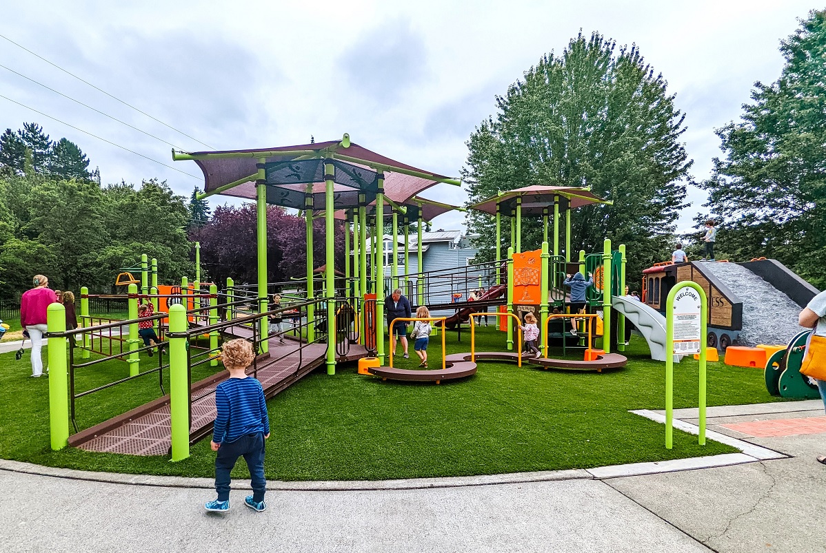 Wide view of new playground equipment at Mercerdale Park on Mercer Island near Seattle; this park is known as Train Park for its train climber