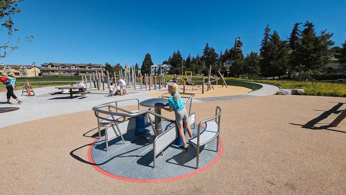 A merry-go-round at Mika’s Playground has a level entry to accommodate mobility devices and wheelchairs
