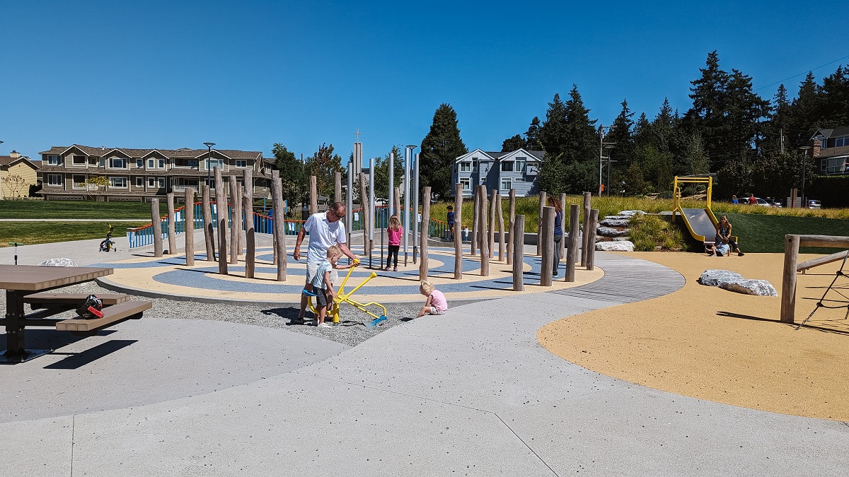 A young child plays with a digger toy at Mika’s Inclusive Playground in Edmonds, a new inclusive playground that welcomes kids with disabilities