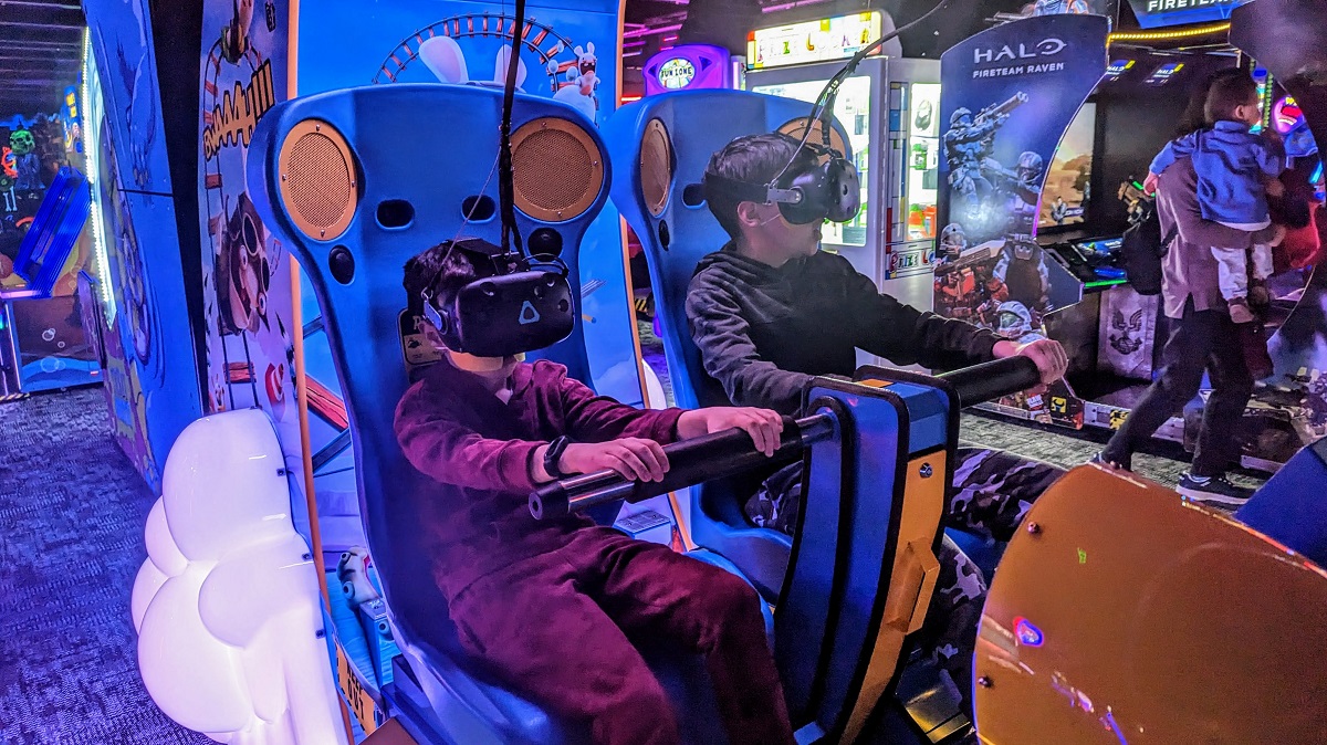 Two boys play a virtual reality game at Monster Mini Golf, newly opened family entertainment venue in Bellevue Washington