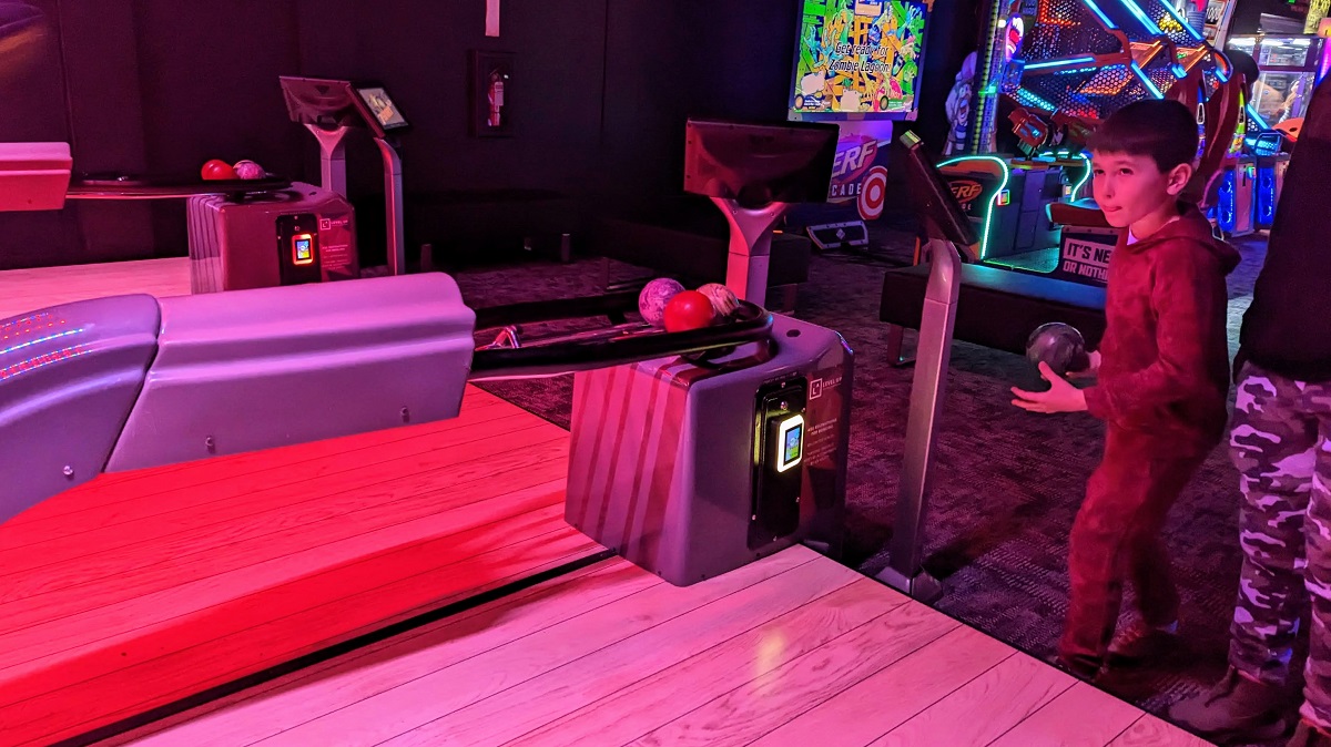 A boy plays a modified golf game at Monster Mini Golf, newly opened family entertainment venue in Bellevue Washington near Seattle fun for families