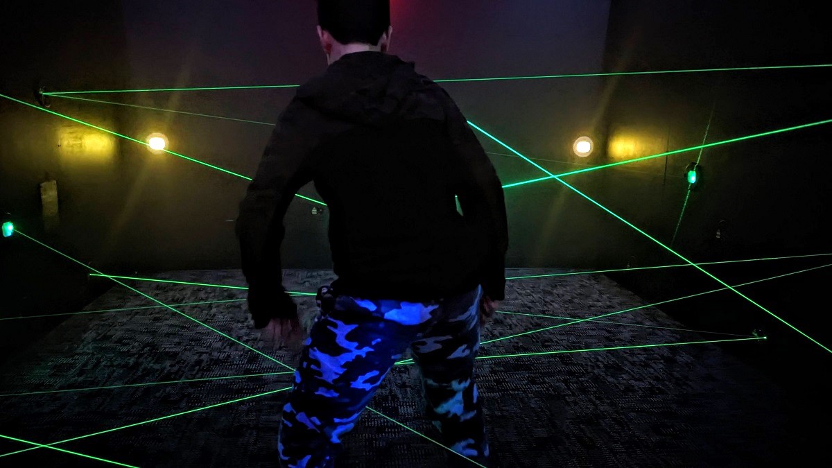 A boy plays in a laser maze game at Monster Mini Golf in Bellevue new family entertainment venue in Factoria Mall near Seattle