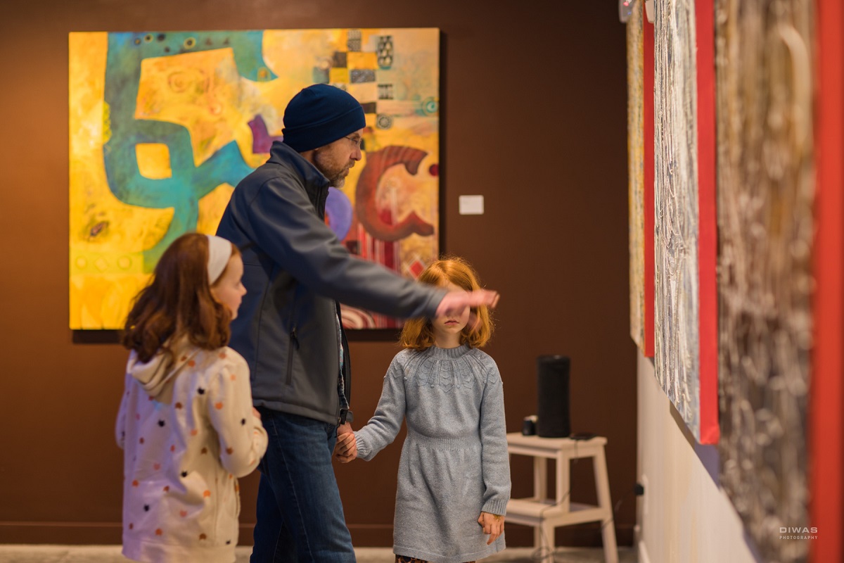 A family look at artwork during the Northwest African American Museum’s grand reopening on Martin Luther King Jr. Day 2023